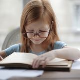 girl-in-blue-short-sleeve-t-shirt-reading-book-3887445